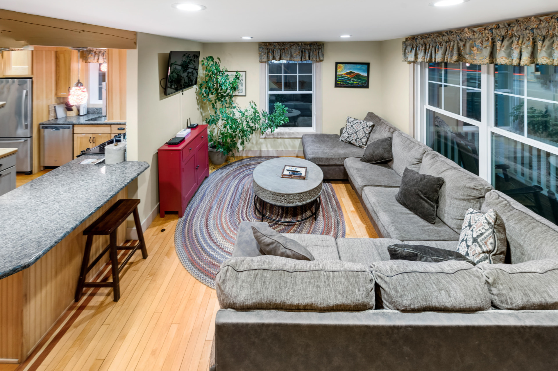 Living room with large sectional sofa and braided rug